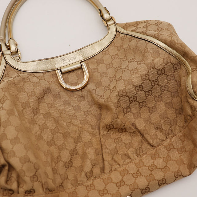 Détail anneau D doré et logo Gucci sur sac Hobo — AMANA Vintage